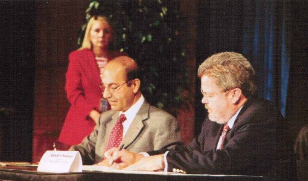 Broadcasting Board of Governors (BBG) Chairman Kenneth Y. Tomlinson and Afghan Minister of Information and Culture Dr. Makhdoom Raheen sign the U.S.-Afghanistan Radio Agreement in Washington, D.C. on October 3, 2002. Photo from Afghanistan Project BBG 2002 Annual Report.