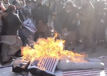 A screenshot from a lengthy raw footage video on the Voice of America (VOA), with the VOA logo, showing the burning of U.S. and Israeli flags in December 2017 without any attached balancing content, explanation of U.S. policy, or commentary.