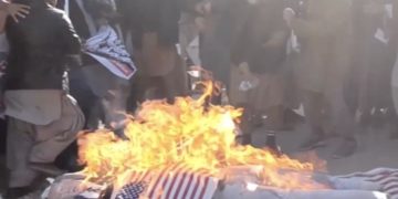A screenshot from a lengthy raw footage video on the Voice of America (VOA), with the VOA logo, showing the burning of U.S. and Israeli flags in December 2017 without any attached balancing content, explanation of U.S. policy, or commentary.