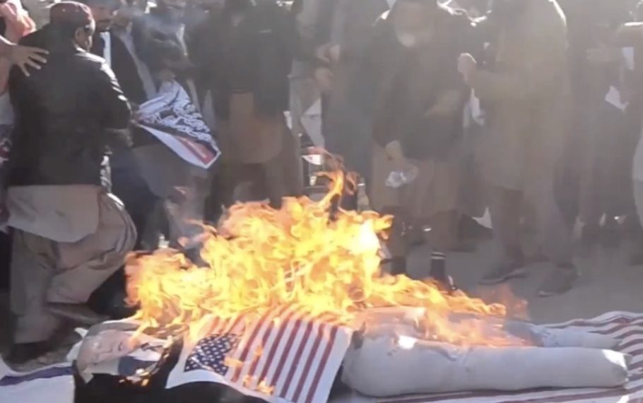 A screenshot from a lengthy raw footage video on the Voice of America (VOA), with the VOA logo, showing the burning of U.S. and Israeli flags in December 2017 without any attached balancing content, explanation of U.S. policy, or commentary.